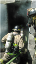 Firefighter Entering a Smokey Building