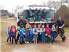 Group of Girl Scouts Standing with Firefighters in Front of a Fire Truck