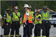 A Group of the Fire and Rescue Team Standing in Vests and Hard Hats