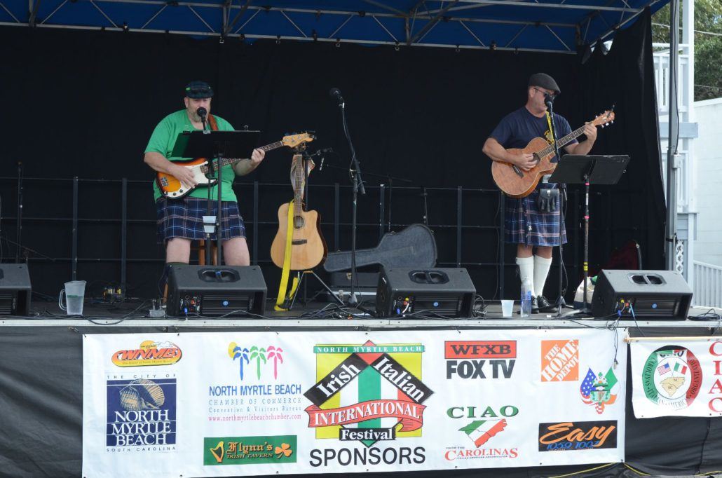 Two Performers in Kilts on a Stage